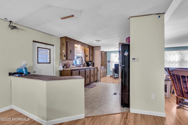 66 Douglas Dr, Jackson, NJ 08527 - kitchen with baseboards, plenty of natural light, and brown cabinets