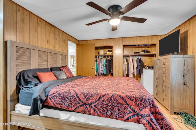 66 Douglas Dr, Jackson, NJ 08527 - bedroom featuring wood walls, multiple closets, ceiling fan, and light wood-style flooring
