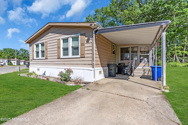 66 Douglas Dr, Jackson, NJ 08527 - manufactured / mobile home with a front lawn, a carport, and concrete driveway