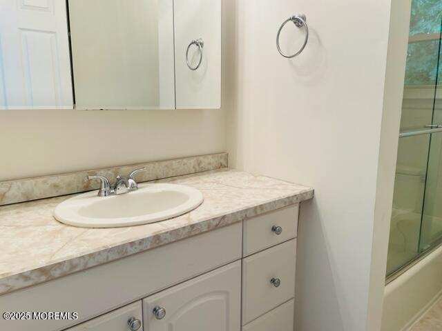 8 Indiana Ct Unit 1016, Matawan, NJ 07747 - bathroom with vanity and enclosed tub / shower combo
