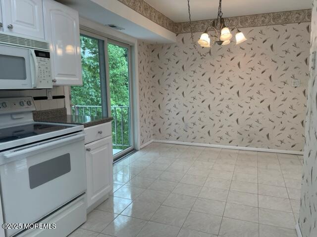 8 Indiana Ct Unit 1016, Matawan, NJ 07747 - kitchen with white appliances, plenty of natural light, a chandelier, white cabinets, and wallpapered walls