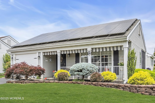 28 Mansfield Ave, Manchester, NJ 08759 - view of front of house with a porch, roof mounted solar panels, an attached garage, and a front lawn