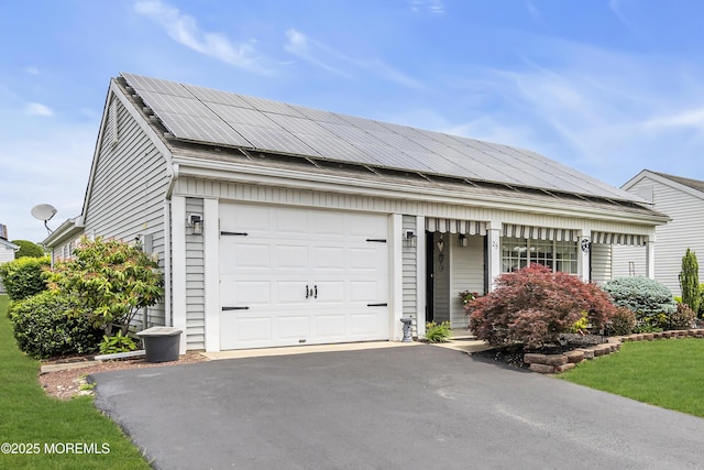 28 Mansfield Ave, Manchester, NJ 08759 - view of front of home featuring driveway, a garage, and solar panels