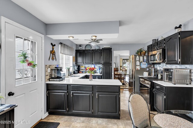 28 Mansfield Ave, Manchester, NJ 08759 - kitchen with stainless steel appliances, a sink, a peninsula, light countertops, and tasteful backsplash