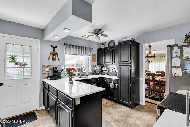 28 Mansfield Ave, Manchester, NJ 08759 - kitchen with dark cabinetry, freestanding refrigerator, a sink, and a peninsula