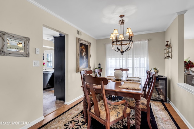 28 Mansfield Ave, Manchester, NJ 08759 - dining space with a chandelier, light wood-style floors, crown molding, and baseboards