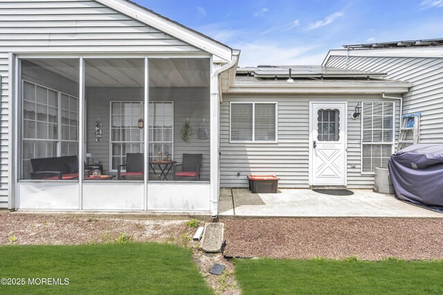 28 Mansfield Ave, Manchester, NJ 08759 - rear view of house featuring a sunroom, solar panels, and a patio