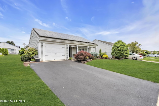 28 Mansfield Ave, Manchester, NJ 08759 - single story home with a garage, driveway, a front yard, and roof mounted solar panels