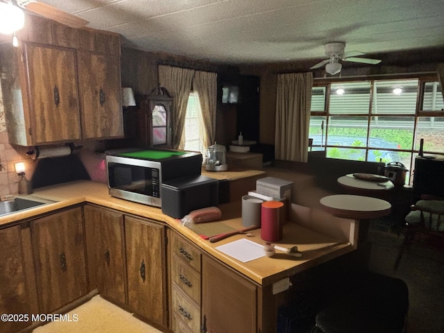 65 Lincoln St, Howell, NJ 07731 - kitchen featuring stainless steel microwave, ceiling fan, plenty of natural light, and brown cabinets
