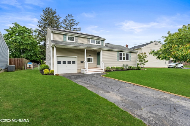183 Crestview Dr, Middletown, NJ 07748 - traditional-style house with central air condition unit, an attached garage, and asphalt driveway
