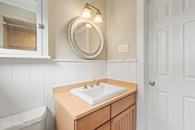 183 Crestview Dr, Middletown, NJ 07748 - bathroom featuring toilet, a decorative wall, vanity, and wainscoting