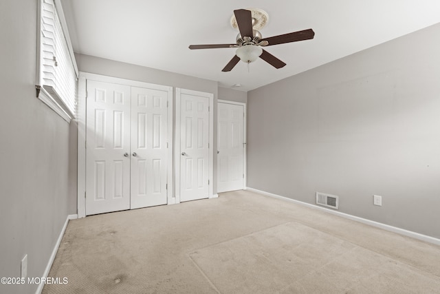 183 Crestview Dr, Middletown, NJ 07748 - unfurnished bedroom featuring two closets, carpet, baseboards, and a ceiling fan