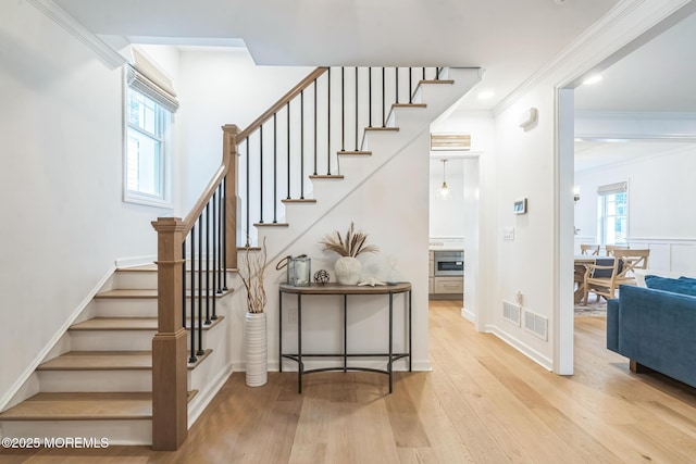 8 W St, Rumson, NJ 07760 - staircase with ornamental molding, wood finished floors, and baseboards
