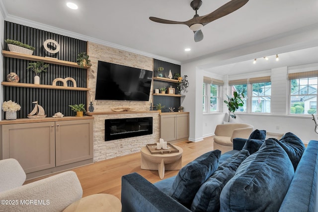8 W St, Rumson, NJ 07760 - living area with light wood-type flooring, ceiling fan, crown molding, a fireplace, and baseboards