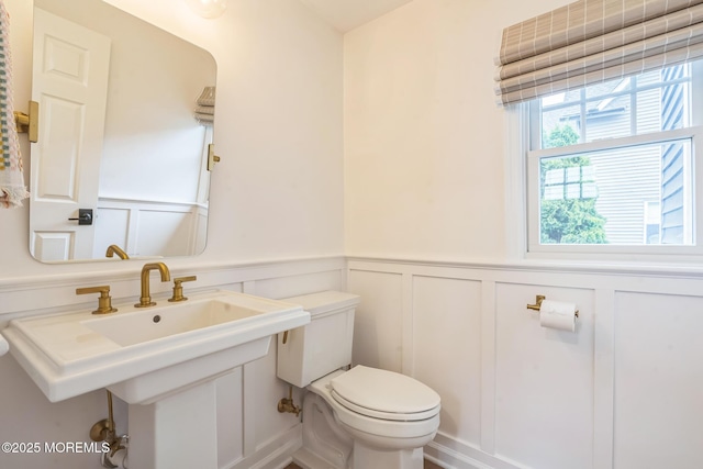 8 W St, Rumson, NJ 07760 - bathroom with a decorative wall, toilet, and a wainscoted wall