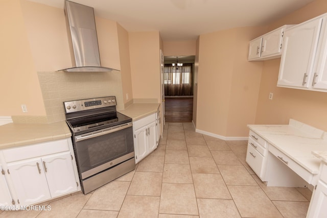 28 Fir Rd Unit 21, Manahawkin, NJ 08050 - kitchen featuring stainless steel electric range oven, wall chimney exhaust hood, white cabinets, and light tile patterned floors