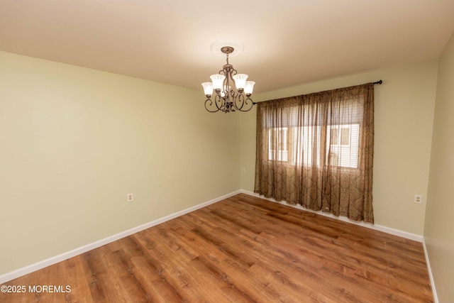 28 Fir Rd Unit 21, Manahawkin, NJ 08050 - spare room featuring a chandelier, wood finished floors, and baseboards