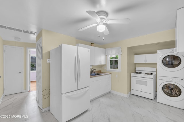 443 Shady Ln, Howell, NJ 07731 - kitchen with white appliances, stacked washer and clothes dryer, a ceiling fan, light marble finish floors, and baseboards
