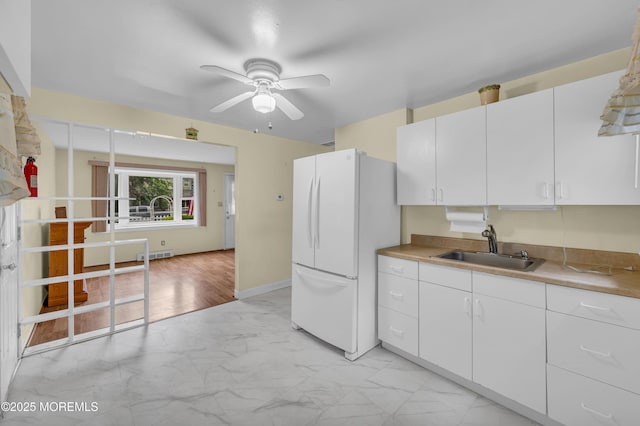 443 Shady Ln, Howell, NJ 07731 - kitchen with freestanding refrigerator, a sink, light marble finish floors, a ceiling fan, and white cabinets