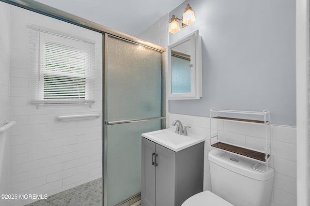 443 Shady Ln, Howell, NJ 07731 - bathroom featuring vanity, tile walls, toilet, a shower stall, and a wainscoted wall