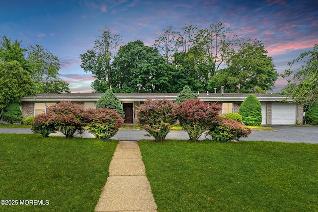 606 Deal Rd, Oakhurst, NJ 07755 - view of front of property with an attached garage, a lawn, asphalt driveway, and brick siding