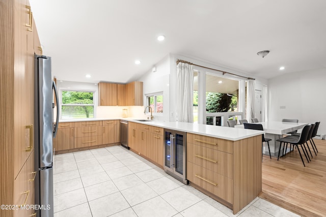 606 Deal Rd, Oakhurst, NJ 07755 - kitchen with wine cooler, stainless steel appliances, a peninsula, modern cabinets, and light countertops