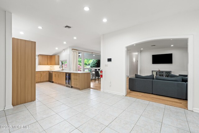 606 Deal Rd, Oakhurst, NJ 07755 - kitchen featuring open floor plan, light tile patterned floors, light countertops, dishwasher, and wine cooler
