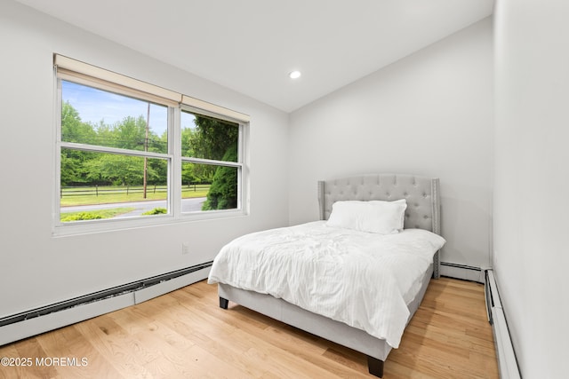606 Deal Rd, Oakhurst, NJ 07755 - bedroom featuring a baseboard heating unit, multiple windows, wood finished floors, recessed lighting, and lofted ceiling