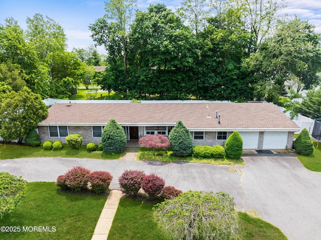 606 Deal Rd, Oakhurst, NJ 07755 - ranch-style home with a front lawn, a garage, and driveway