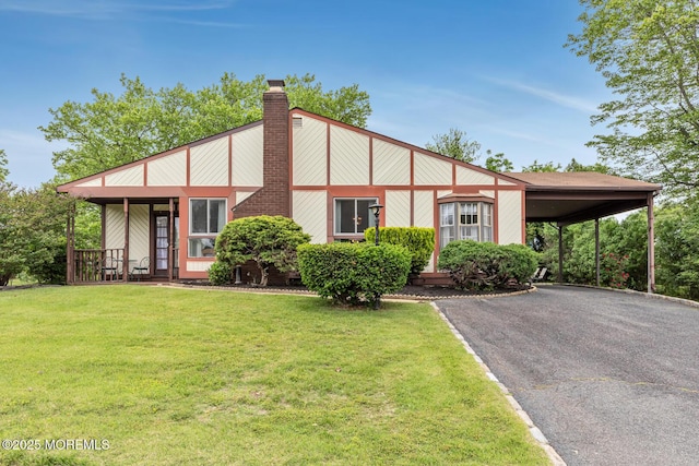 4 Mason Dr, Hazlet, NJ 07730 - view of front facade featuring a front lawn, driveway, a chimney, and a carport