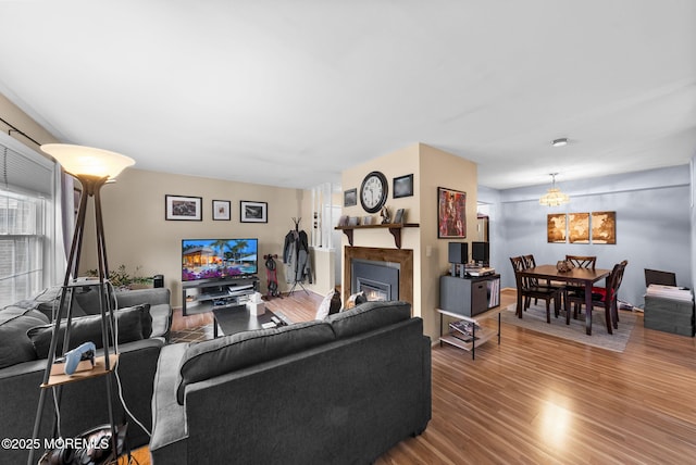 516 Wellington Pl, Aberdeen, NJ 07747 - living area with wood finished floors, a glass covered fireplace, and a chandelier