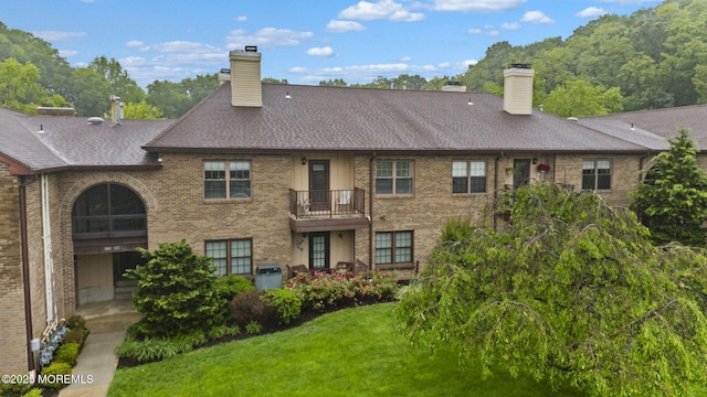 516 Wellington Pl, Aberdeen, NJ 07747 - back of house with a chimney, brick siding, and a lawn