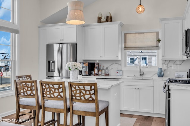 123 W Cove Way, Lavallette, NJ 08735 - kitchen featuring appliances with stainless steel finishes, a sink, healthy amount of natural light, and white cabinets