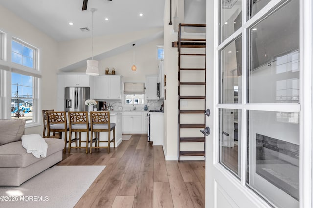 123 W Cove Way, Lavallette, NJ 08735 - living area featuring a towering ceiling, light wood-type flooring, ceiling fan, and recessed lighting