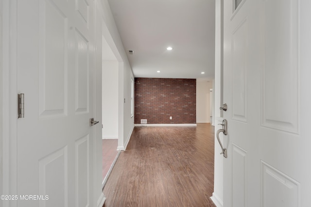 717 Zlotkin Cir Unit 1, Freehold, NJ 07728 - hallway featuring brick wall, wood finished floors, baseboards, and recessed lighting