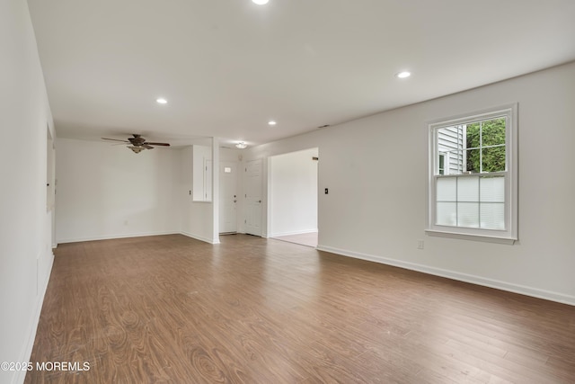 717 Zlotkin Cir Unit 1, Freehold, NJ 07728 - unfurnished living room with wood finished floors, ceiling fan, baseboards, and recessed lighting