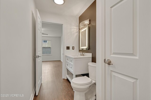 717 Zlotkin Cir Unit 1, Freehold, NJ 07728 - half bathroom with toilet, vanity, wood finished floors, and baseboards