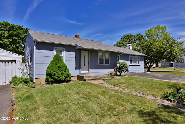 68 Elm St, Beachwood, NJ 08722 - view of front of home with a chimney and a front lawn