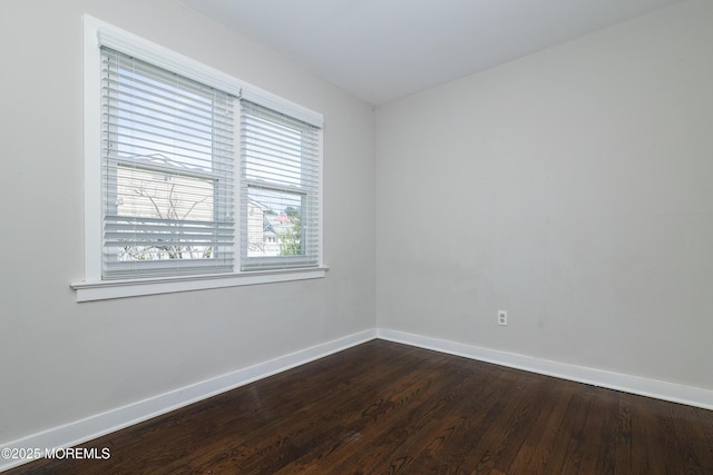 68 Elm St, Beachwood, NJ 08722 - spare room featuring baseboards and dark wood-style flooring