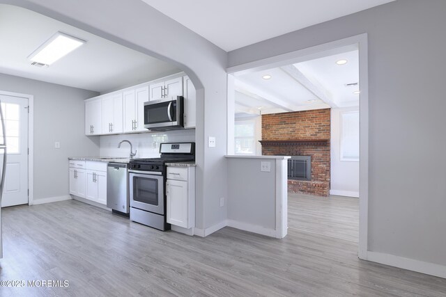 68 Elm St, Beachwood, NJ 08722 - kitchen with stainless steel appliances, baseboards, light wood-style floors, white cabinets, and recessed lighting