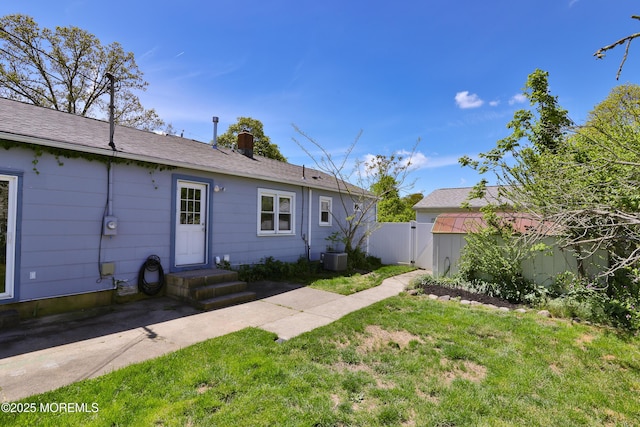 68 Elm St, Beachwood, NJ 08722 - rear view of house with a chimney, a gate, and central AC