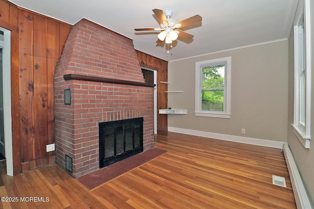 1600 Lawrence Ave, Toms River, NJ 08757 - unfurnished living room with a brick fireplace, wood finished floors, baseboards, a ceiling fan, and baseboard heating