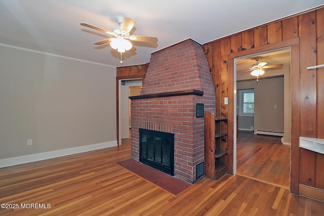 1600 Lawrence Ave, Toms River, NJ 08757 - unfurnished living room featuring ceiling fan, a baseboard radiator, a fireplace, baseboards, and crown molding