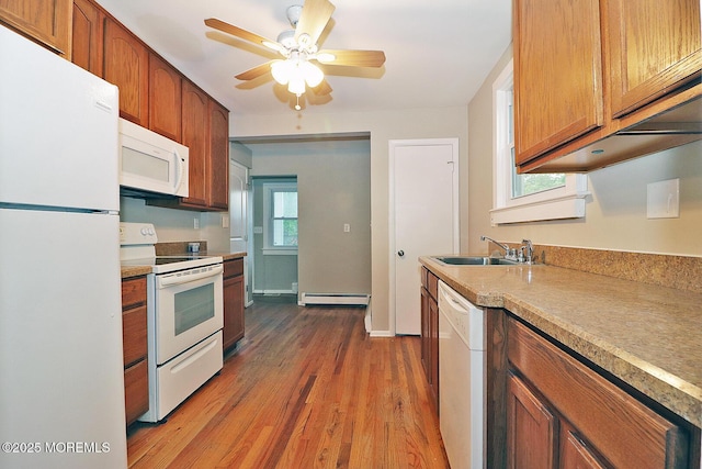 1600 Lawrence Ave, Toms River, NJ 08757 - kitchen with white appliances, a sink, a baseboard radiator, wood finished floors, and light countertops