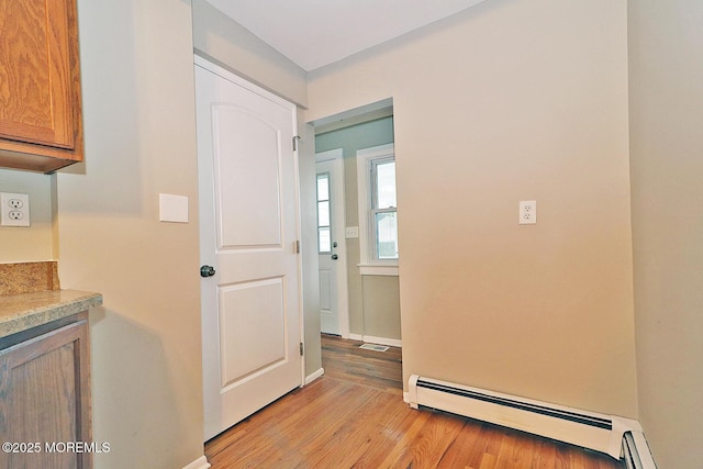 1600 Lawrence Ave, Toms River, NJ 08757 - hallway with baseboard heating, light wood-type flooring, and baseboards