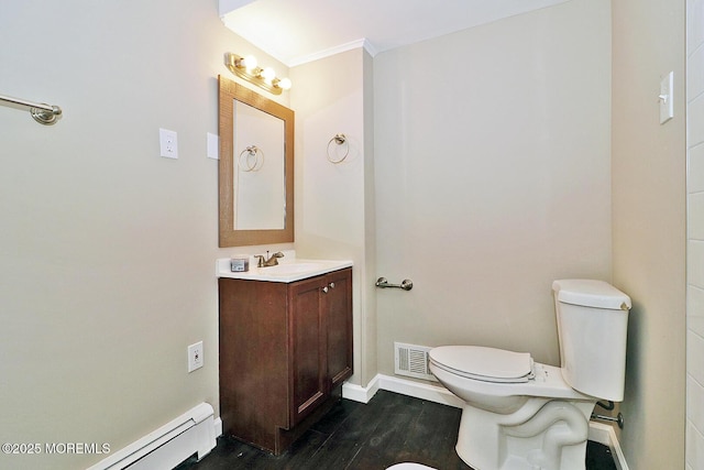 1600 Lawrence Ave, Toms River, NJ 08757 - bathroom featuring toilet, a baseboard heating unit, vanity, wood finished floors, and baseboards