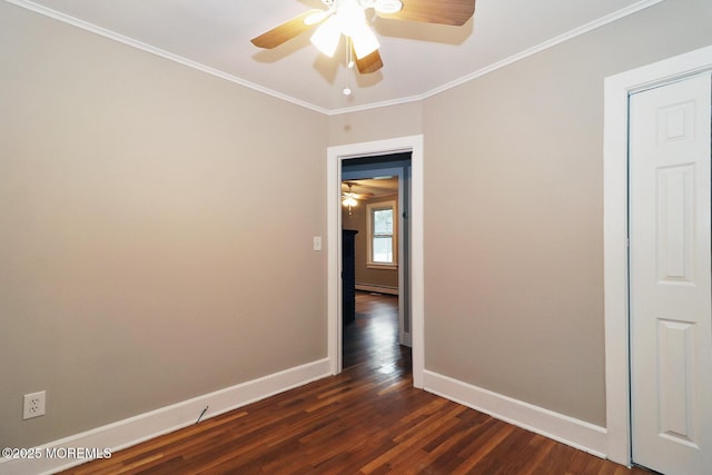 1600 Lawrence Ave, Toms River, NJ 08757 - spare room featuring ceiling fan, baseboards, dark wood finished floors, ornamental molding, and a baseboard heating unit