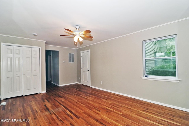 1600 Lawrence Ave, Toms River, NJ 08757 - unfurnished bedroom with dark wood finished floors, baseboards, crown molding, a ceiling fan, and a closet