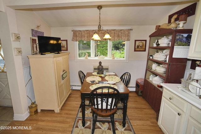 503 Page Ave, Allenhurst, NJ 07711 - dining space with a baseboard radiator, a chandelier, light wood-type flooring, a wainscoted wall, and vaulted ceiling