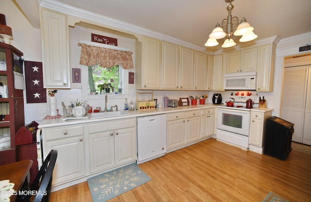 503 Page Ave, Allenhurst, NJ 07711 - kitchen featuring white appliances, a chandelier, a sink, light countertops, and a wainscoted wall